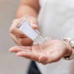 Woman Hands Using Wash Hand Sanitizer Gel Dispenser