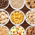 variety of breakfast cereals displayed in bowls