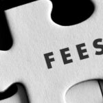 "FEES" written in black ink on white puzzle piece